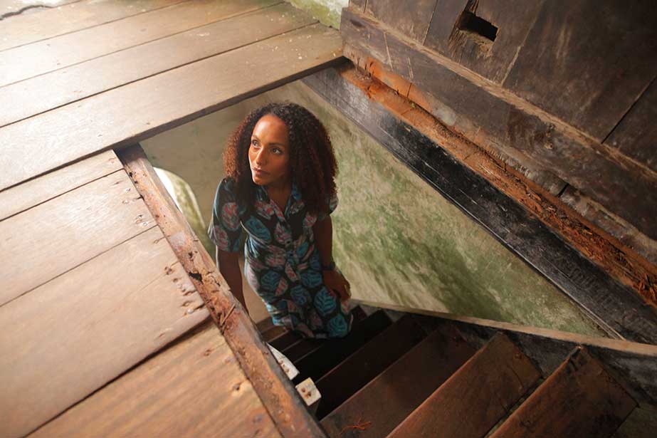 Afua Hirsch climbing the hidden stairs to the Governor Chamber in Elmina Castle, Ghana.