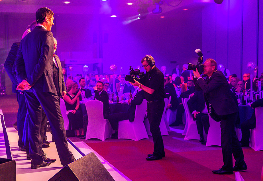 Vernon Kay on stage being photographed at the TrustFord Awards